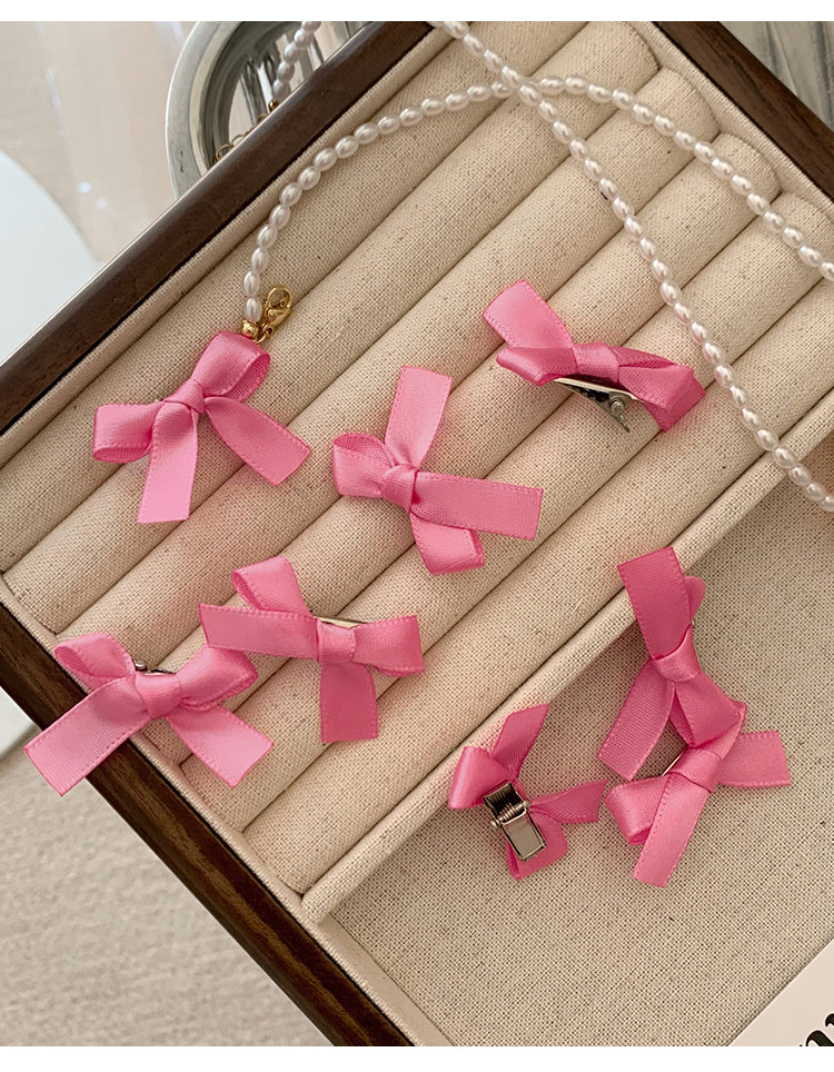8 Pink Ribbon Bow Hair Clips On The Forehead