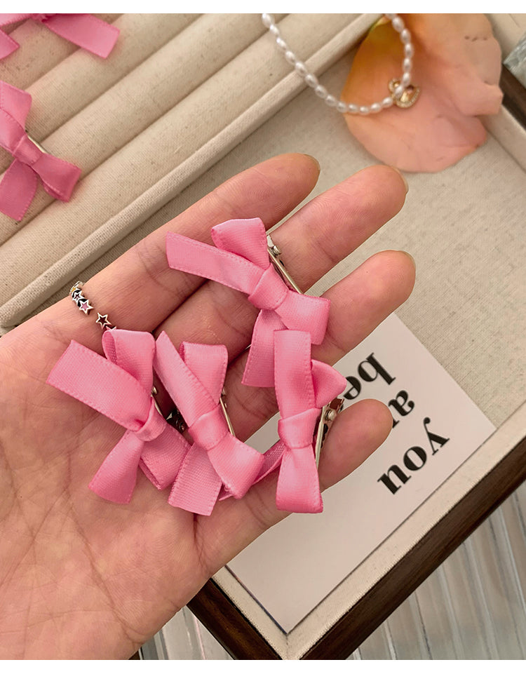 8 Pink Ribbon Bow Hair Clips On The Forehead