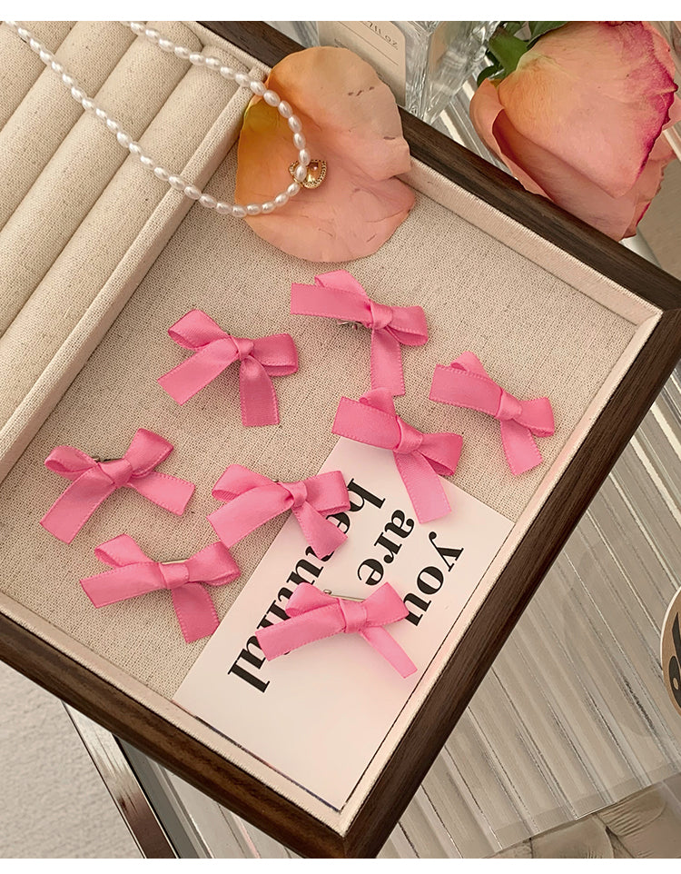 8 Pink Ribbon Bow Hair Clips On The Forehead