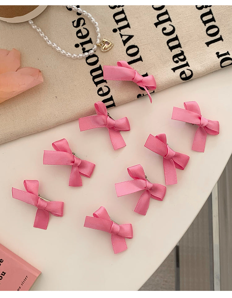 8 Pink Ribbon Bow Hair Clips On The Forehead