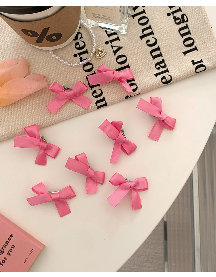 8 Pink Ribbon Bow Hair Clips On The Forehead